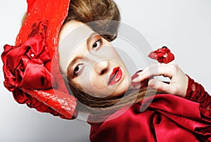 Fashion model in bright red costume and red hat