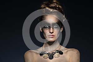 Fashion model with creative dark make up and copyspace