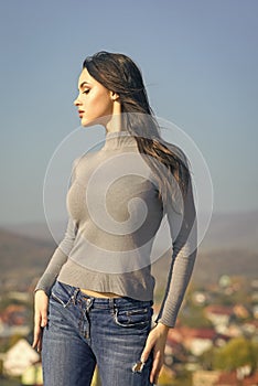 Fashion model with fit body pose in sweater jeans