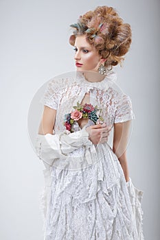 Fashion Model in Flossy White Dress and Wreath of Flowers photo