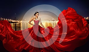 Fashion Model in Fluttering Dress in Night City Street Lights, Elegant Woman in Red Long Gown beauty portrait photo