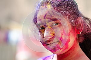Fashion Model Girl colorful face paint. Beauty fashion art portrait of beautiful girl with powerder paint holi, abstract makeup.