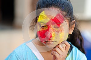 Fashion Model Girl colorful face paint. Beauty fashion art portrait of beautiful woman girl with flowing liquid paint holi,