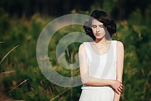 Fashion model. Girl with cute hairstyle in nature