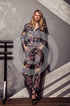 Fashion Model girl full length portrait in the patterned suit.