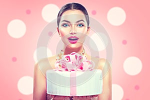 Fashion model girl holding beautiful party or birthday cake