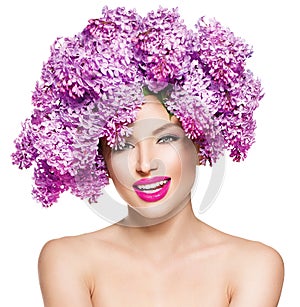 Fashion model girl with lilac flowers hairstyle