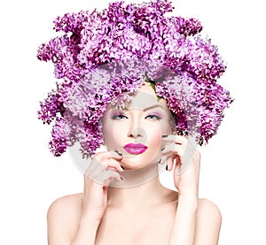 Fashion model girl with lilac flowers hairstyle