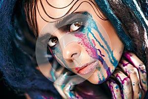 Fashion model girl portrait with colorful paint make up. woman bright color makeup. Closeup of vogue style lady face, Art des