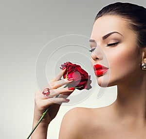 Fashion model girl with red rose in her hand