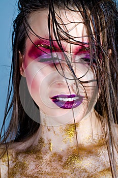 Fashion model girl with trendy make-up. Golden bright sparkles
