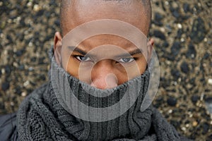 Fashion model with gray winter scarf covering face