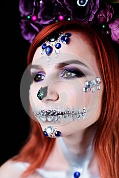 Fashion model with halloween skull makeup with glitter and rhinestones