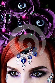 Fashion model with halloween skull makeup with glitter and rhinestones