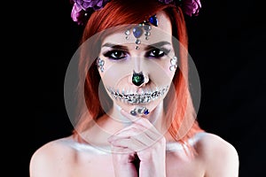 Fashion model with halloween skull makeup with glitter and rhinestones