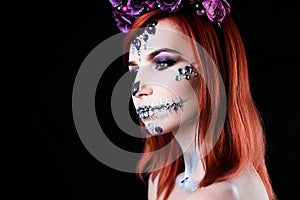 Fashion model with halloween skull makeup with glitter and rhinestones