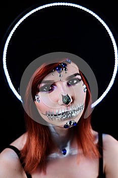 Fashion model with halloween skull makeup with glitter and rhinestones