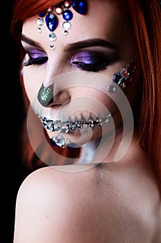 Fashion model with halloween skull makeup with glitter and rhinestones