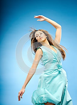 Fashion model jumps with arm up