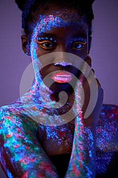 Fashion model lady in neon light, portrait of charming model with fluorescent make-up