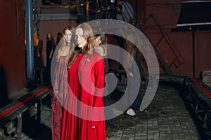 Fashion model in long wide designers dress at night show