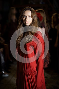 Fashion model in long wide designers dress at night show