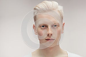 Fashion model male on white. Handsome albino guy closeup.