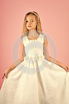 Fashion model on pink background, beauty. Child girl in stylish glamour dress, elegance. Look, hairdresser, makeup