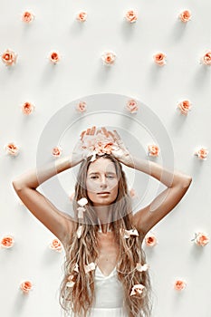 Fashion model portrait with roses and golden dust