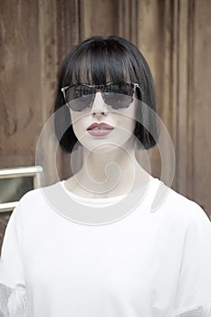 Fashion model pose on wooden background.