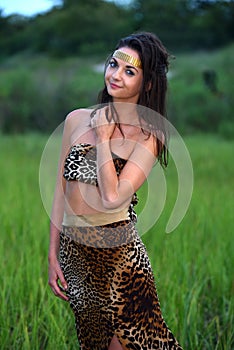 Fashion model posing at outdoor location wearing animal print resort dress