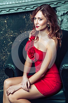 Fashion model posing in red dress.