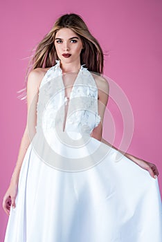 Fashion model or princess at prom. Wedding fashion and beauty salon. Woman on pink background in summer dress. girl