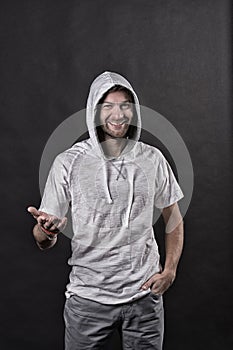 Fashion model smile in hoodie tshirt. Happy man with beard in hood. Bearded man wear casual sweatshirt. Active lifestyle