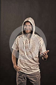 Fashion model smile in hoodie tshirt. Happy man with beard in hood. Bearded man wear casual sweatshirt. Active lifestyle