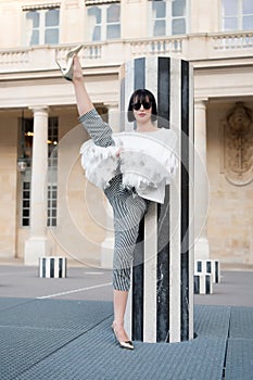 Fashion model in sunglasses on square. Fashion and vogue. Yoga and sport concept. Sensual woman with brunette hair