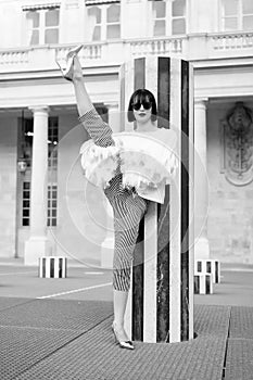 Fashion model in sunglasses on square. Fashion and vogue. Yoga and sport concept. Sensual woman with brunette hair