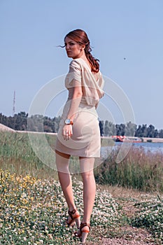 Fashion model walking in field