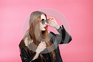 Fashion model wearing black in sunglasses, beautiful young woman