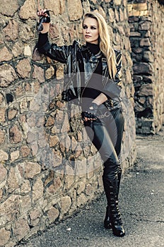 Fashion model wearing leather pants and jacket