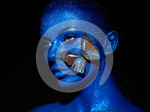 Fashion model woman with blue butterfly