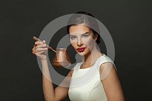 Fashion model woman brunette with coffee in ibric portrait
