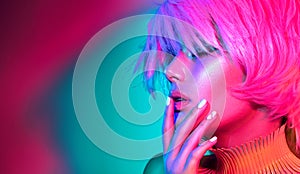 Fashion model woman in colorful bright lights