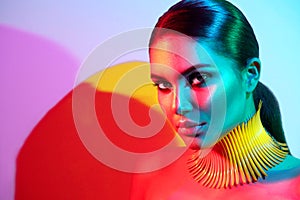 Fashion model woman in colorful bright lights