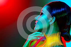 Fashion model woman in colorful bright lights