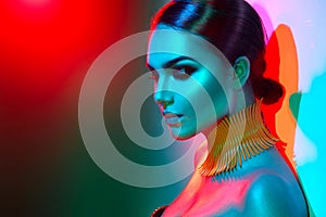 Fashion model woman in colorful bright lights posing