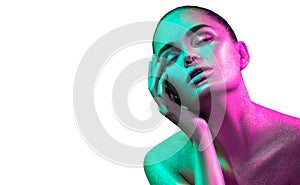 Fashion model woman in colorful bright sparkles and neon lights posing in studio, portrait of beautiful girl