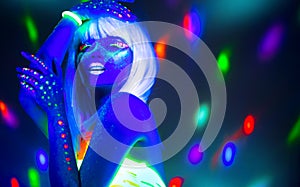 Fashion model woman dancing in neon light, disco night club. Beautiful dancer model girl colorful bright fluorescent make-up