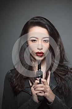 Fashion model woman with dark red lips in studio