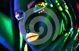 Fashion model woman in neon light. Beautiful model girl with colorful fluorescent makeup